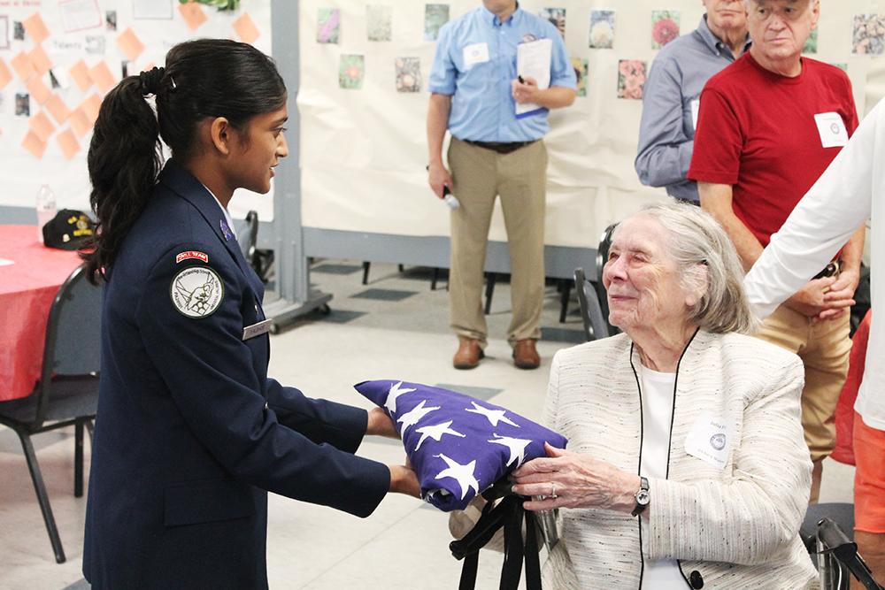 Mars Area High School senior Reva Kalbhor presents a folded American Flag to 102-year-old Julia Parsons, who served as a code breaker in the U.S. Naval Reserve (Women’s Reserve) or WAVES (Women Accepted for Volunteer Emergency Ser-vice) during World War II, at a Veterans Club Breakfast on Sept. 8.